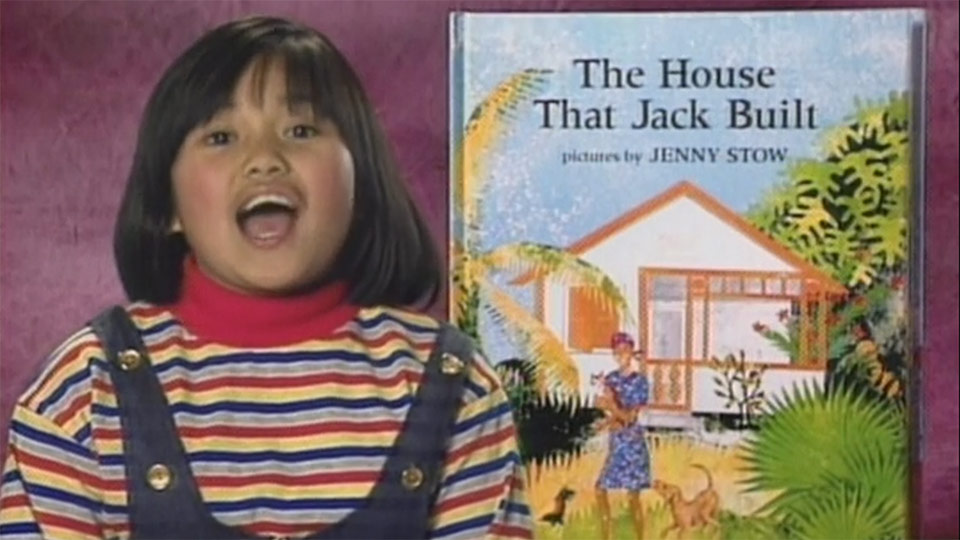 Girl speaking next to a book