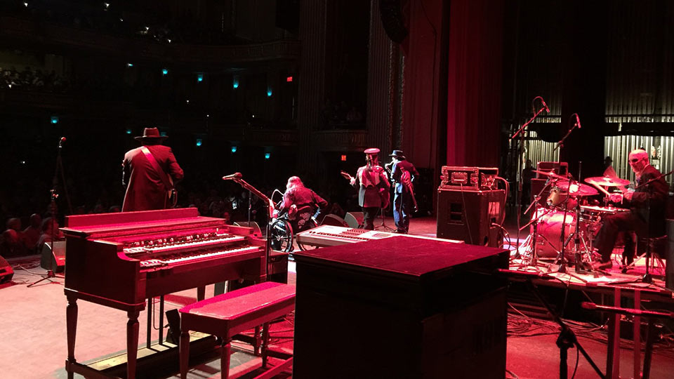 A blues band performs on stage