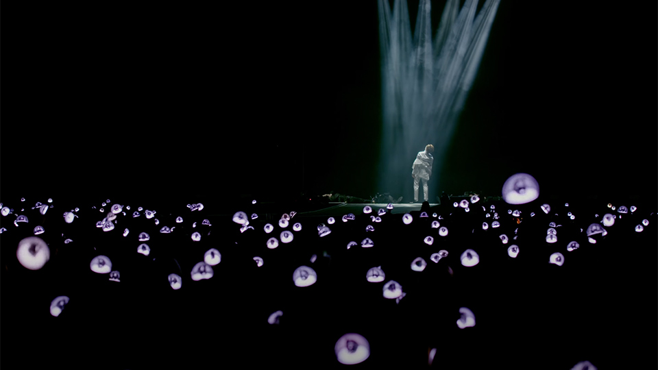 man standing on stage with lights